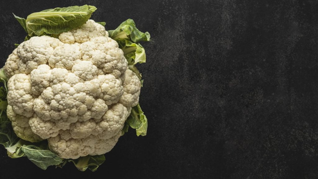 top view cauliflower with leaves copy space