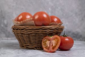 whole juicy red tomatoes wicker basket placed marble