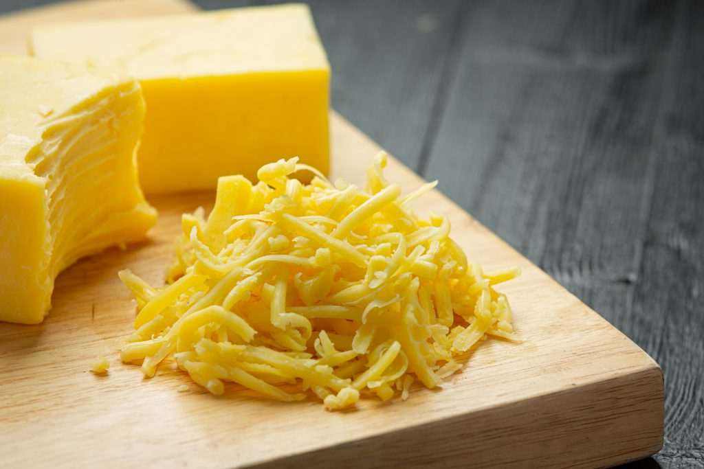 cheddar cheese dark wooden surface