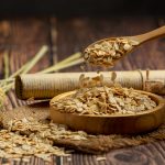 raw barley grain wooden background