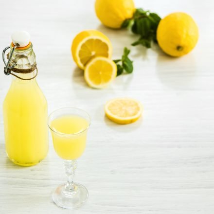 italian traditional liqueur limoncello with lemon