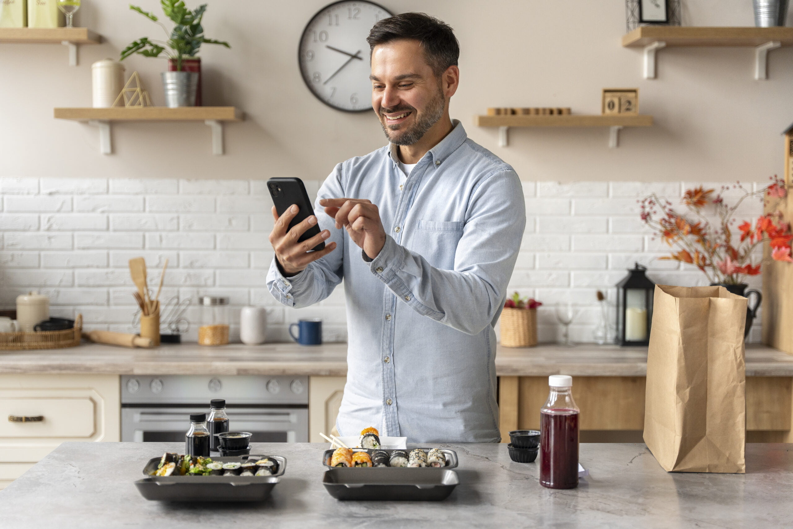 side view smiley man holding smartphone scaled