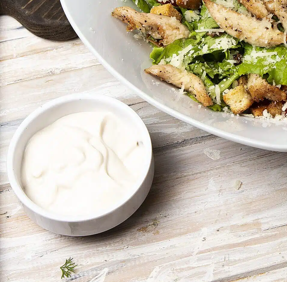 Chicken Parmesan Caesar Salad With Lettuce Cherry Tomatoes Inside White Bowl Served With Sauce Bread E1620385599710