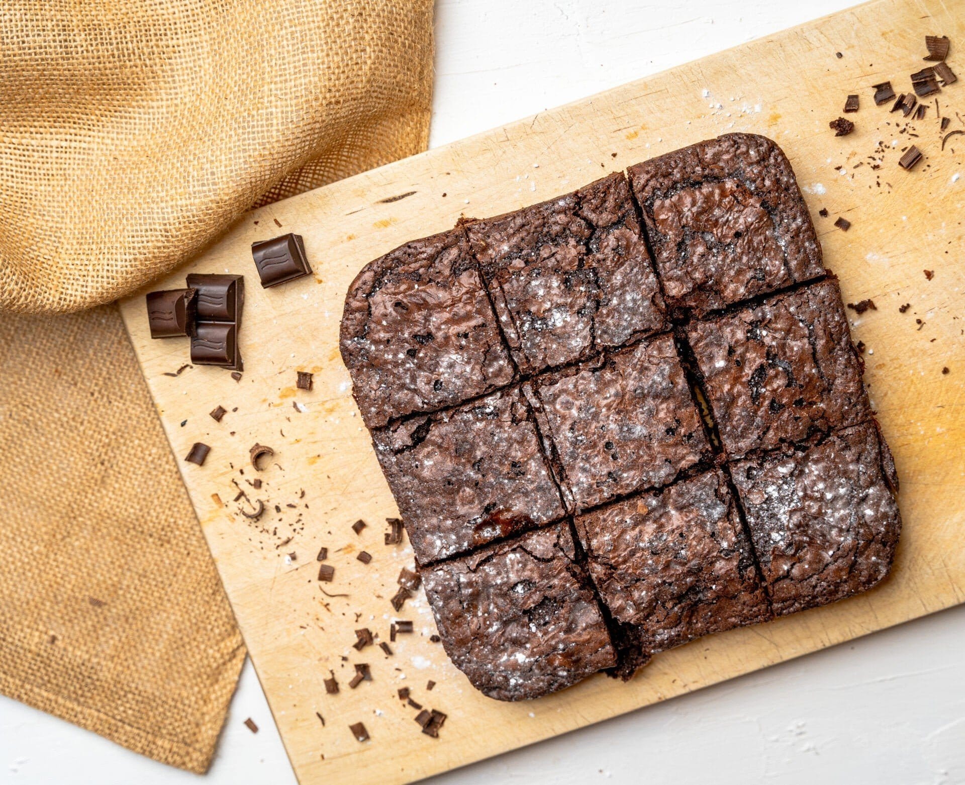 Overhead Shot Of Freshly Baked Brownies On Wooden Board